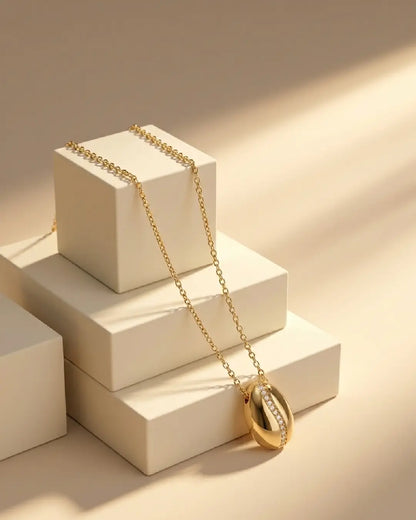 Gold tonned finish anti tarnish necklace with a pendant on a beige surface